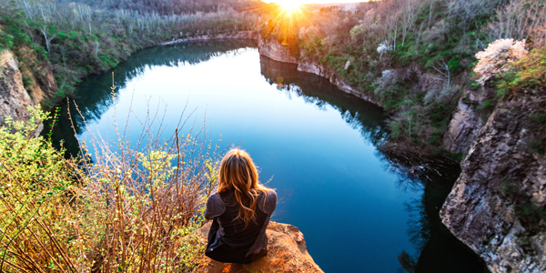 Student looking down at quarry at sunset